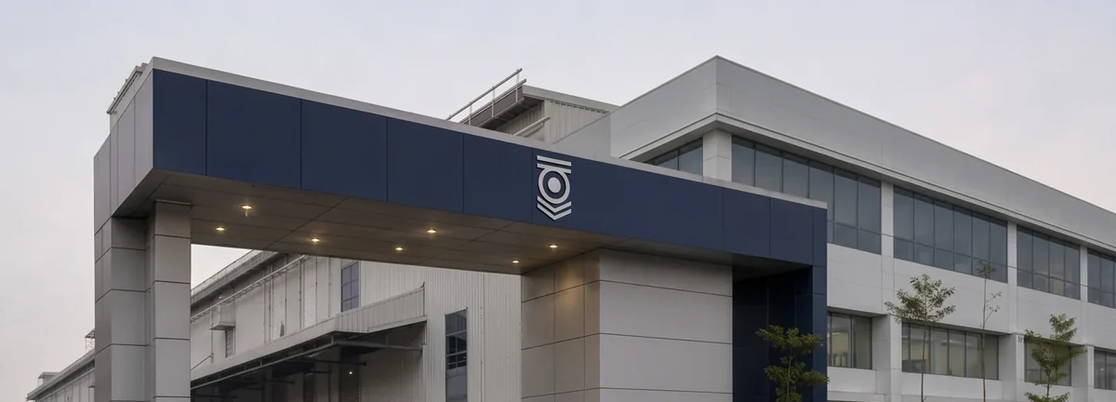 Navy canopy band with a brand mark spanning the entrance to a low commercial building