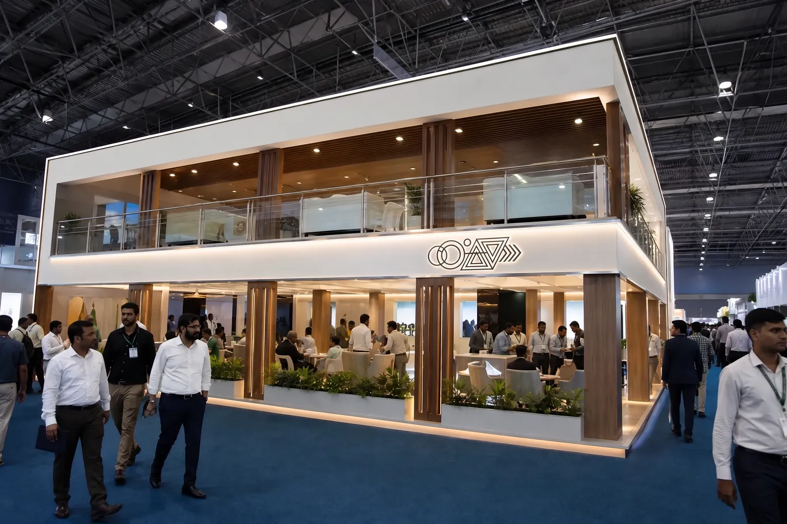 Double-deck exhibition stall in a busy hall, visitors walking past the open ground floor